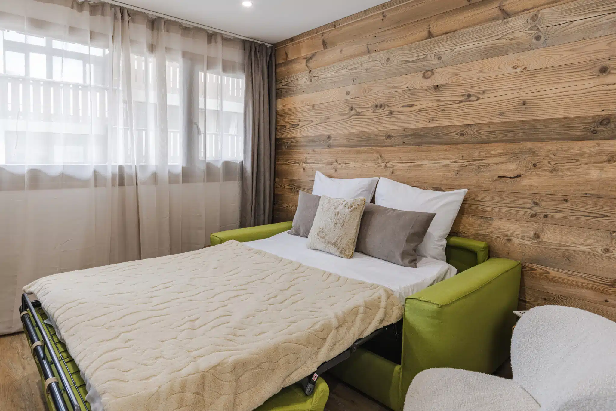 canapé lit confortable, appartement Les Caribous à Praz-sur-Arly, proche du lac